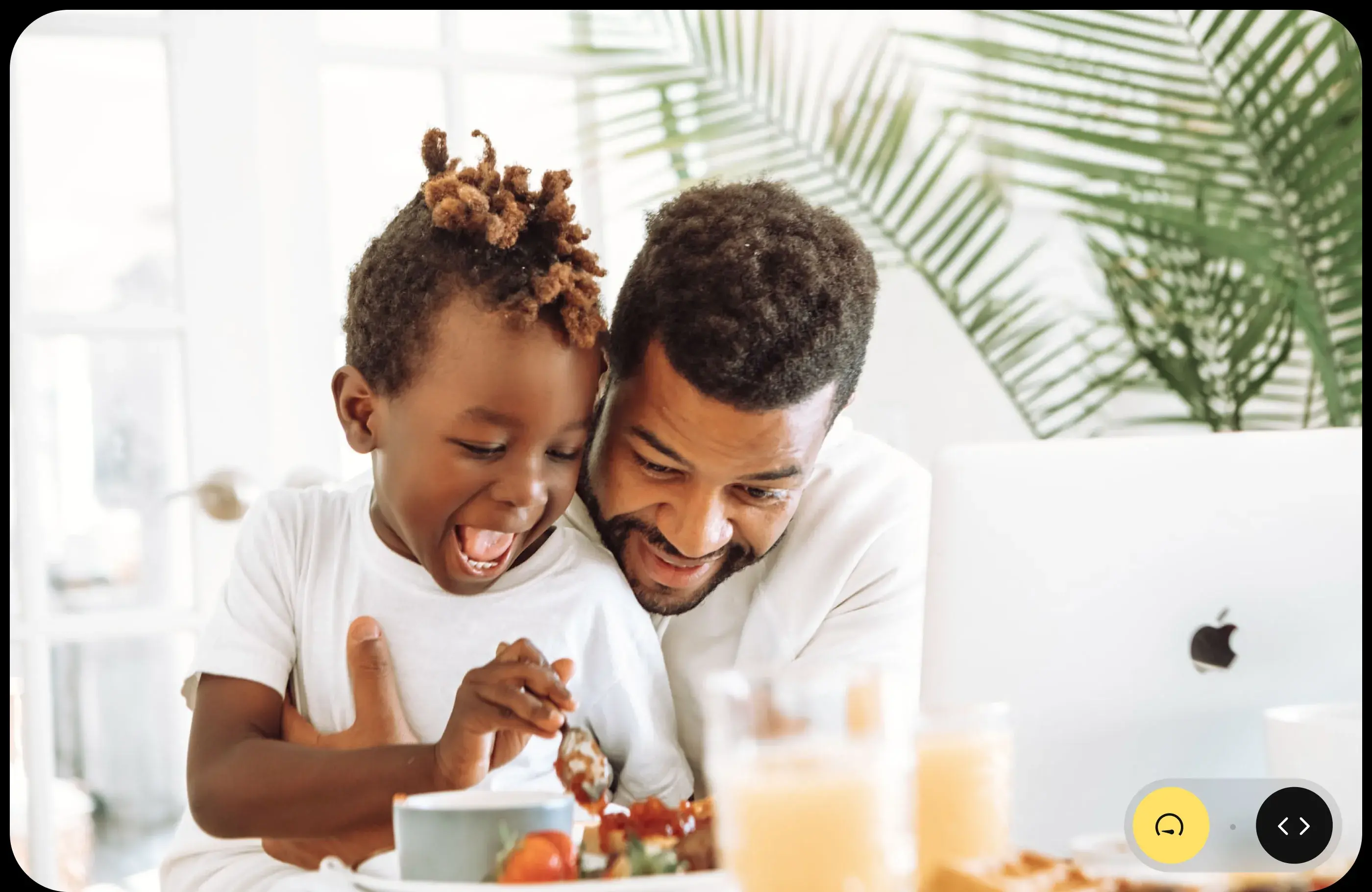 Father and child sharing a happy mealtime, a family moment supported by the app design. Father and child sharing a happy mealtime, a family moment supported by the app design.