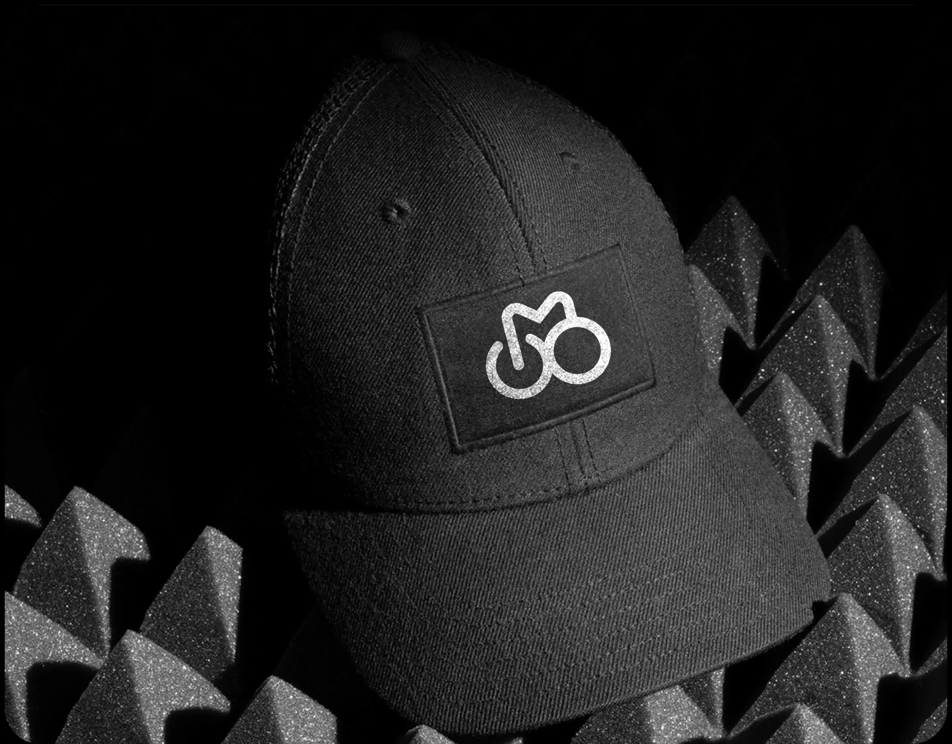 Design mockup of a black baseball cap, illustrating potential branding for a sport or wellness app. Design mockup of a black baseball cap, illustrating potential branding for a sport or wellness app.