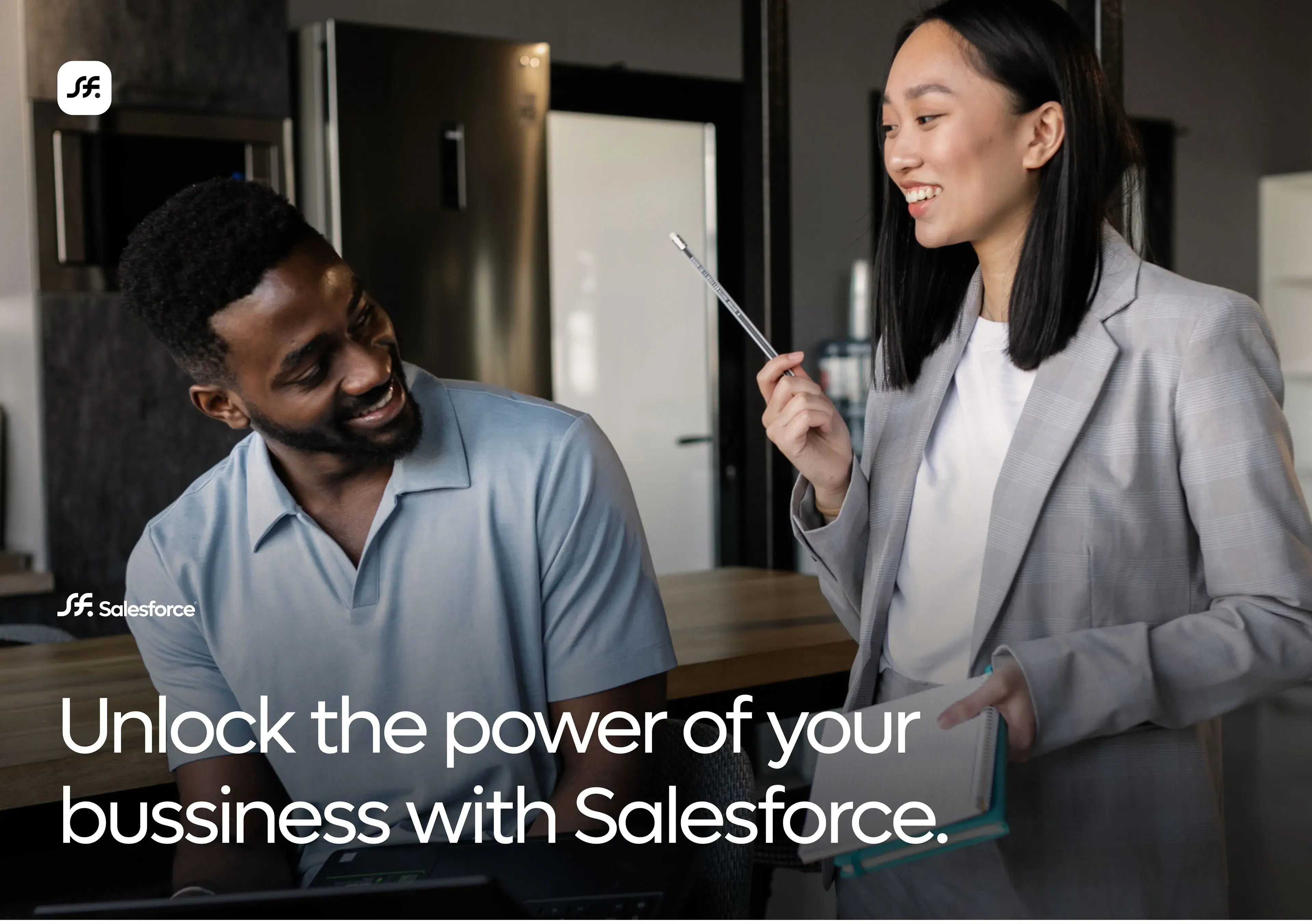 Two business professionals talk near a screen showing 'Unlock the power of your business with Salesforce'. Two business professionals talk near a screen showing 'Unlock the power of your business with Salesforce'.
