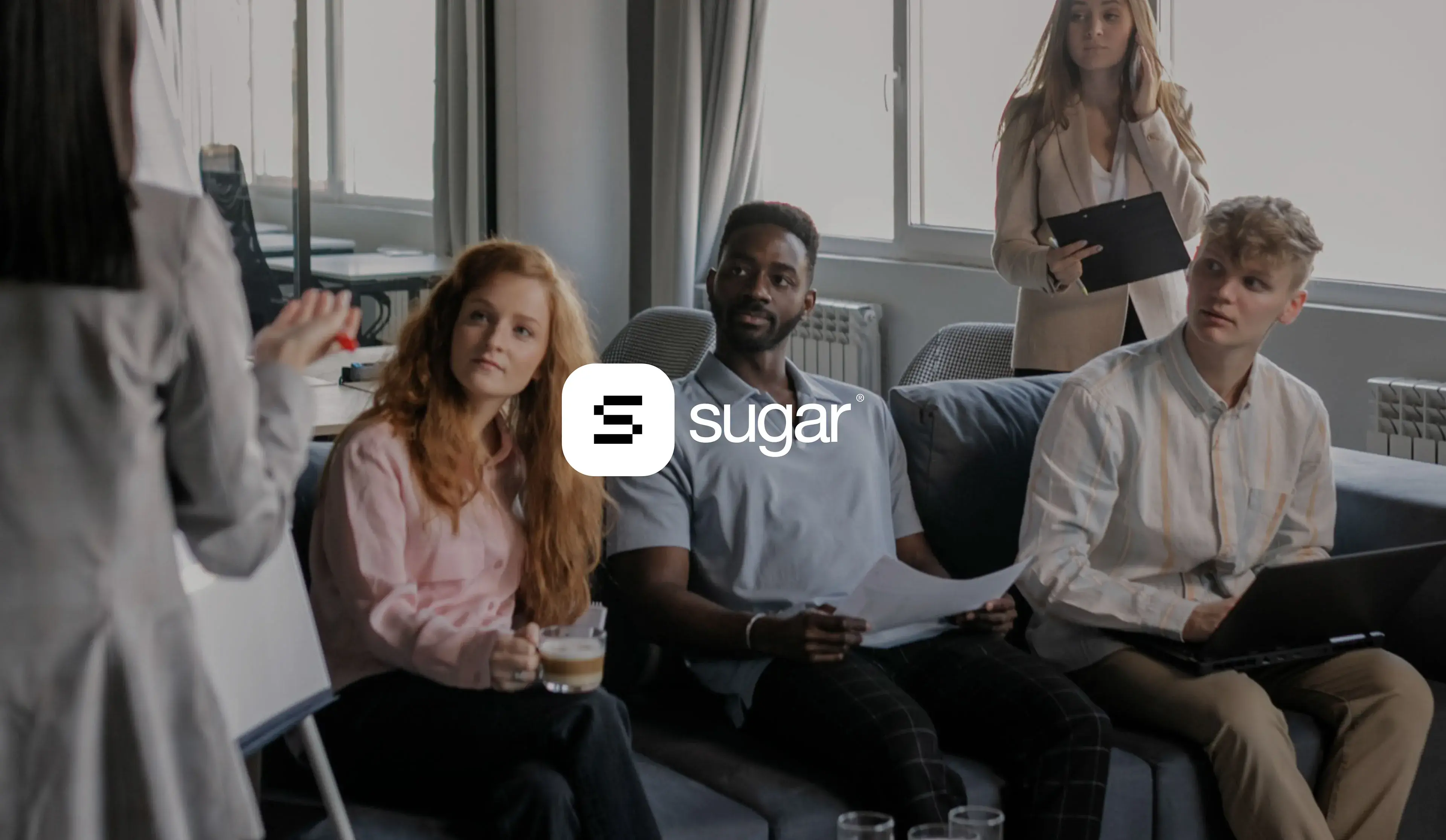 Scene of a team presentation and collaboration session discussing SugarCRM SaaS UX/UI design.