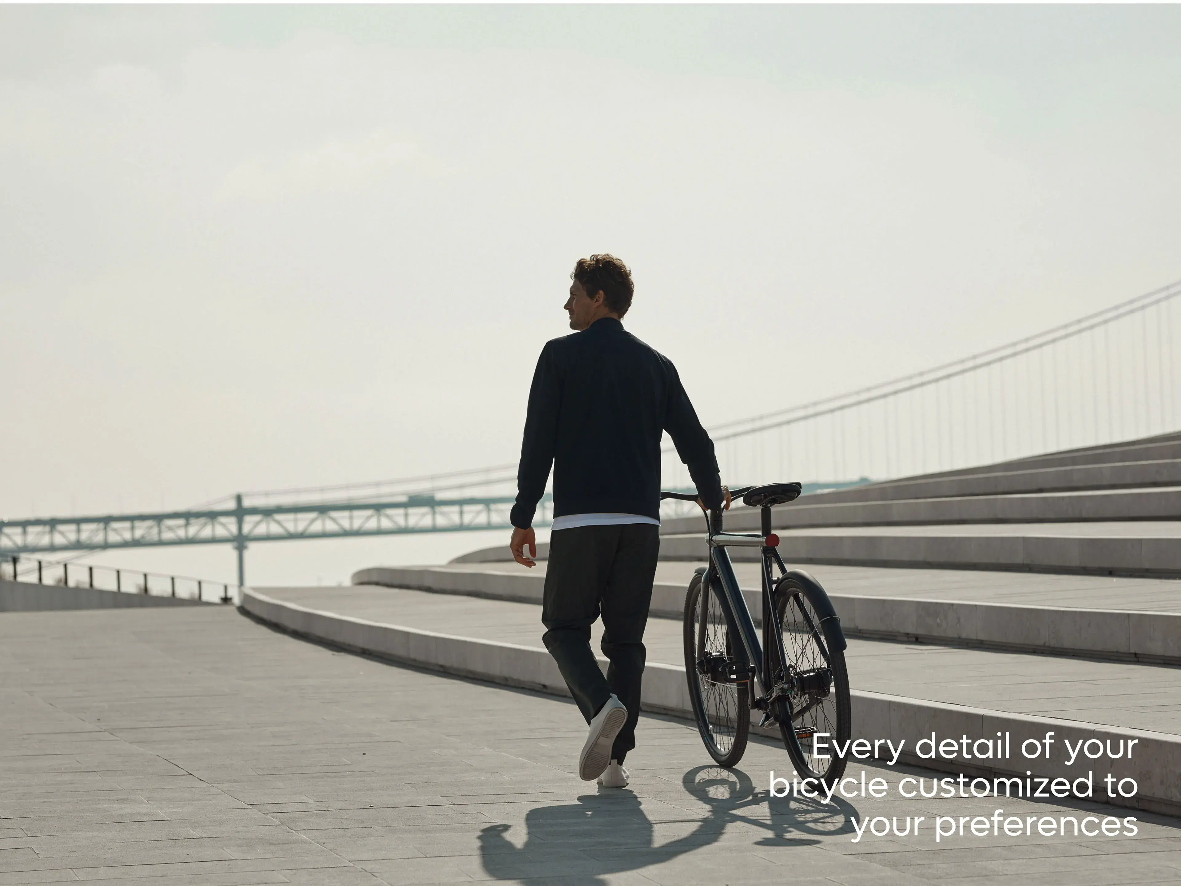 VanMoof S3 e-bike with a person and text "Every detail of your bicycle customized to your preferences," highlighting app features. VanMoof S3 e-bike with a person and text "Every detail of your bicycle customized to your preferences," highlighting app features.